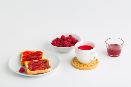 Cup of red tea and toasted breadの写真素材
