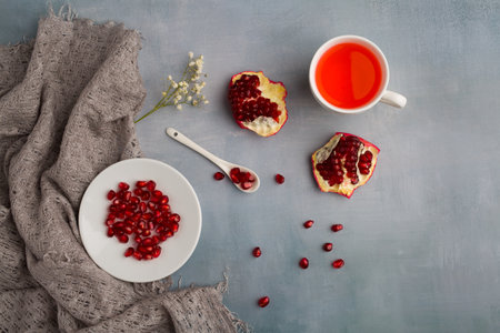 Red juice pomegranate composition on green background, still lifeの写真素材