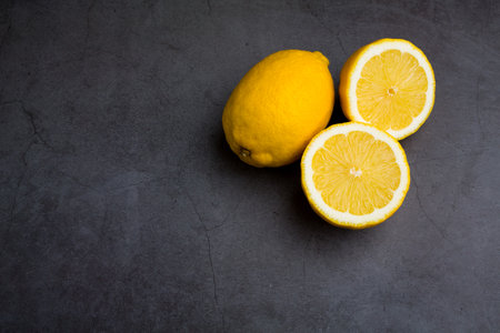 Fresh ripe lemon on dark stone background. Top view copy spaceの写真素材