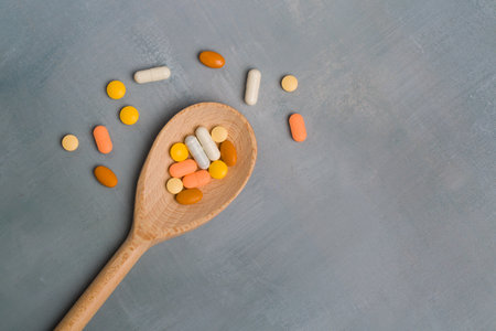 Assorted pharmaceutical medicine pills, tablets and capsules on blue background. Copy space for textの写真素材