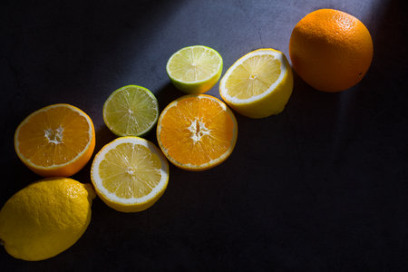 Citrus fruits on a black background. Lemons, limes and orangesの写真素材