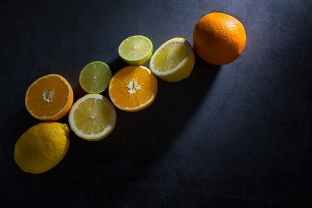 Lemons, oranges and lemons on a black background.