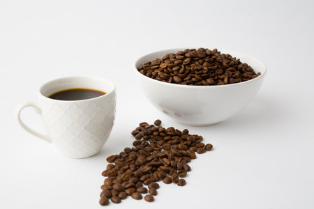 Coffee cup with roasted beans on white background. Top view with copy space for your textの写真素材