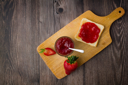 Strawberry jam in the glass jar with fresh berries. Close up.の写真素材