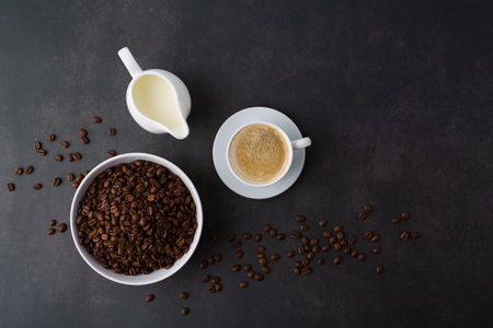 Coffee cup with roasted beans on stone background. Top view with copy space for your textの写真素材