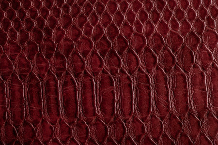 Beautiful red, pink bright snake or crocodile skin, reptile skin texture, multicolored close-up as a...