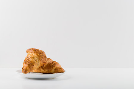 Croissants on a white plate isolated on a white background.