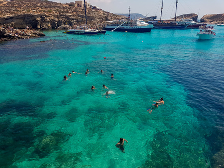 BLUE LAGOON, COMINO, MALTA - AUGUST 09, 2018: Blue Lagoon on a sunny day in Comino, Malta. Some...