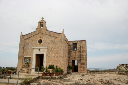 MALTA - AUGUST 06, 2018: an ancient church on an isolated Malta street on a cloudy day.のeditorial素材