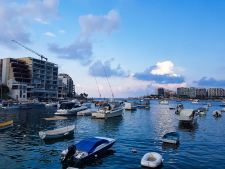 SLIEMA, MALTA - AUGUST 05, 2018: A port with many small boats and buildings on a summer day in Sliema, Malta.のeditorial素材