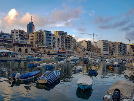 SLIEMA, MALTA - AUGUST 05, 2018: A port with many small boats and buildings on a summer day in Sliema, Malta.のeditorial素材