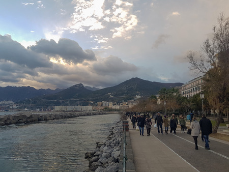 SALERNO, ITALY - DECEMBER 31, 2018: people walking near the sea in the city of Salerno.のeditorial素材