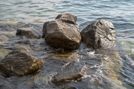 Stone in the sea with blue water