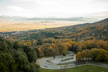 Natural landscape with trees, mountains and some houses, on a cold day near the Sanctuary of Greccio, Lazio, Italy.のeditorial素材