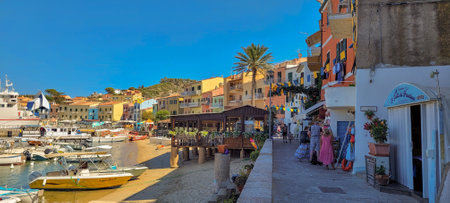Isola del Giglio, Italy - July, 2022: view of Giglio Porto with boats, people, shops and buildings.のeditorial素材