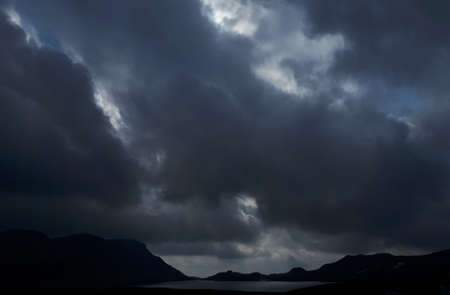 Landscape with stormy clouds over the mountainsの写真素材