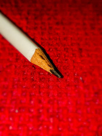 sharp pencil on a red backgroundの写真素材