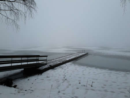 wooden pier in an almost frozen lake - Bogstad GÃ¥rdの写真素材