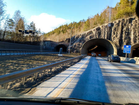 cars in front of the tunnel on the roadの写真素材