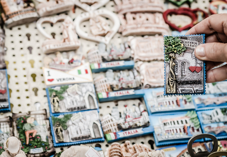 Close up of a lady who chooses a souvenir for her lover promising respect for mutual love. Concept of loyalty in love. Horizontal viewの写真素材