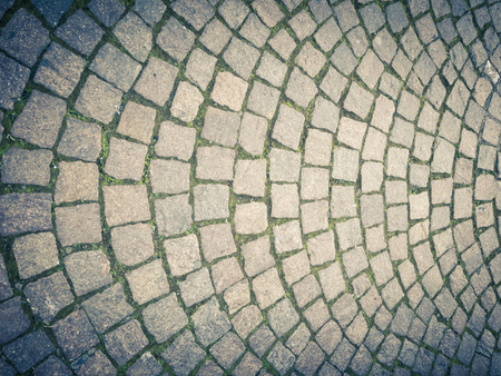 Ancient type of road paving, made of lava stone squares, with a harmoniously semi-circular structure. Vertical viewの写真素材