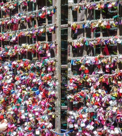 Verona, Italy â 19 July 2014 : Close-up of the entrance door to Juliet's house in Verona. Full of colorful padlocks left by lovers on the promise of respect for mutual love. Concept of loyalty in love. Square view.のeditorial素材
