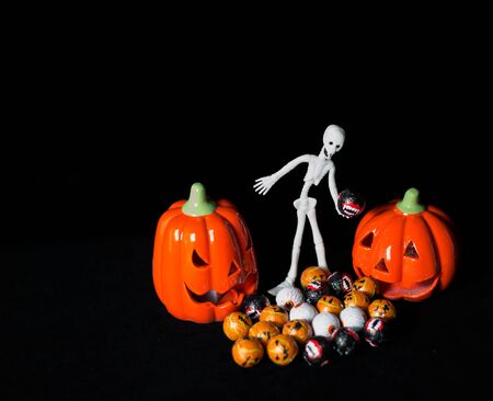 Useful background for halloween, with skeletons, sweets and very colorful pumpkinsの写真素材