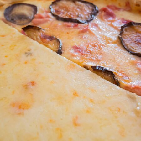 Close up of an Italian pizza with fried eggplant and cheese. Traditional dish
