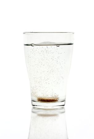 Fizzy tablet in a glass of waterの写真素材