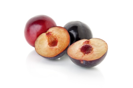 cut plums isolated on white backgroundの写真素材