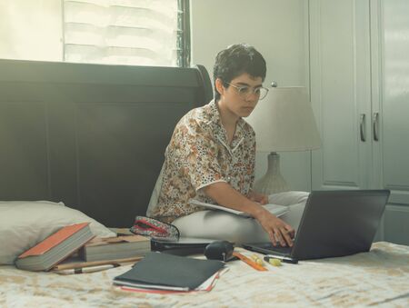 Woman working from home typing on a laptop