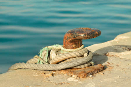 Moored old ship with ropes in the port. Outdoors.の写真素材