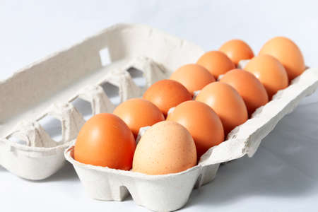A dozen brown eggs in your carton