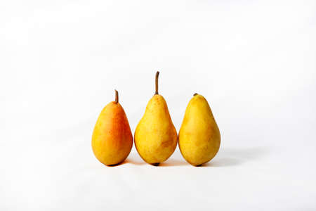 Pears. Three ripe juicy pears close-up arranged on white backgroundの写真素材
