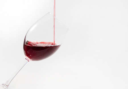 Red wine poured in a glass isolated on white.Drinkの写真素材