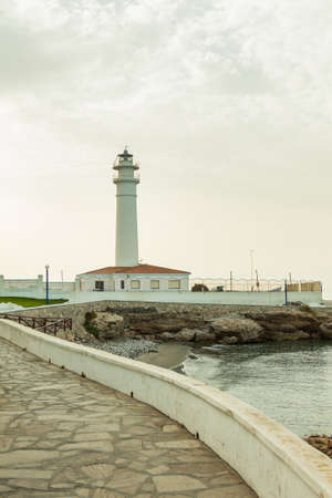 Torrox, Spain - June 27, 2012: View of the whitewashed lighthouse along the rugged coastline of Torrox in the province of Malaga, Andalusia, Spain, Western Europe.のeditorial素材