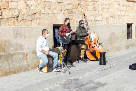 Salamanca, Castilla y Leon, Spain - January 19, 2021: Three street Musicians play music at roadside in the city center of Salamancaのeditorial素材