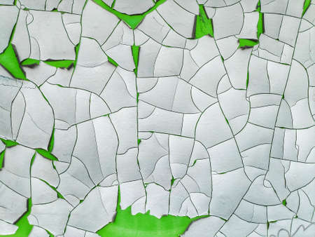 Chipped peeling paint, white and green grunge background texture in an old wall