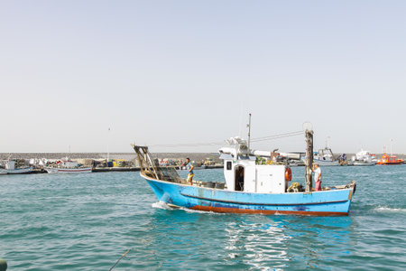 Torrox, Spain - June 29, 2012: Fishing boat coming back to pier after a hard working day in Torrox,...