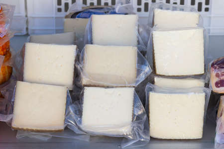 Traditional salted sheep milk cheese for sale at supermarketの写真素材
