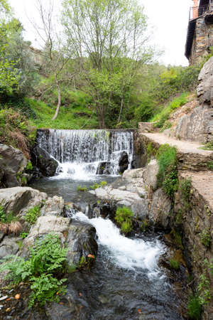 A beautiful waterfall on the natural swimming pool in Arrago river in the town of Descargarmaria, Spainの写真素材
