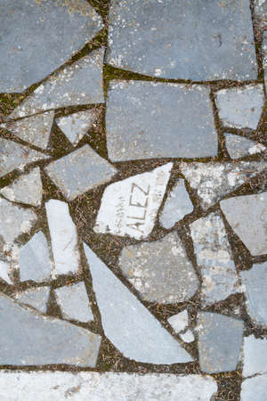 Path made from broken pieces of old gravestones from the burial graves of a cemeteryの写真素材
