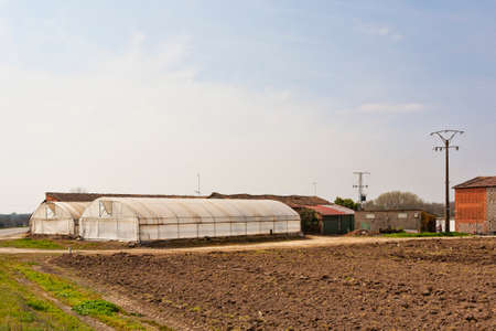 A plastic agriculture greenhouse hothouse in summer farm garden in Extremadura