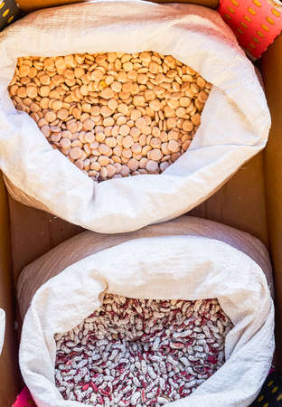 Beans of various colors and lupins in sacks for sale in bulk at a local flea market grown in nearby orchardsの写真素材