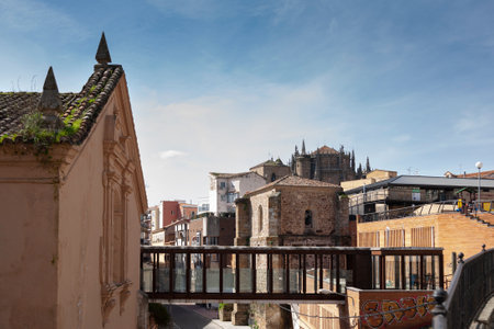 Plasencia, Caceres, Spain - February 27, 2021: Church and Convent of San Francisco, today desacralized, with a modern access bridge and the Cathedral of Plasencia in the backgroundのeditorial素材