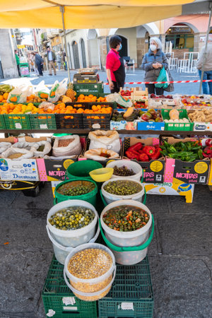 Plasencia, Spain - March 23, 2021: People in the traditional market that takes place every Tuesday in the main squareのeditorial素材