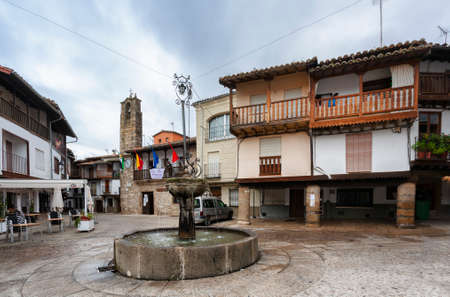Villanueva de la Vera, Spain - March 08, 2021: Granite stone fountain in the square of the sculptor Aniceto Marinas, example of the typical and traditional architecture of the townのeditorial素材