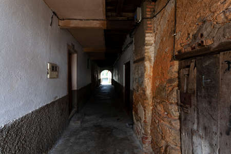 Villanueva de la Vera, Spain - March 08, 2021: A tunnel from one street to another giving shelter from the rain at the entrance to the housesのeditorial素材