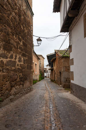 Villanueva de la Vera, Spain - March 08, 2021: View of an old and traditional street with buildings and stone floors shows the typical architecture of the areaのeditorial素材