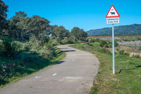 Plasencia, Spain - March 24, 2021: A sign of danger for loose animals on a country road dedicated to the activity of walkingのeditorial素材